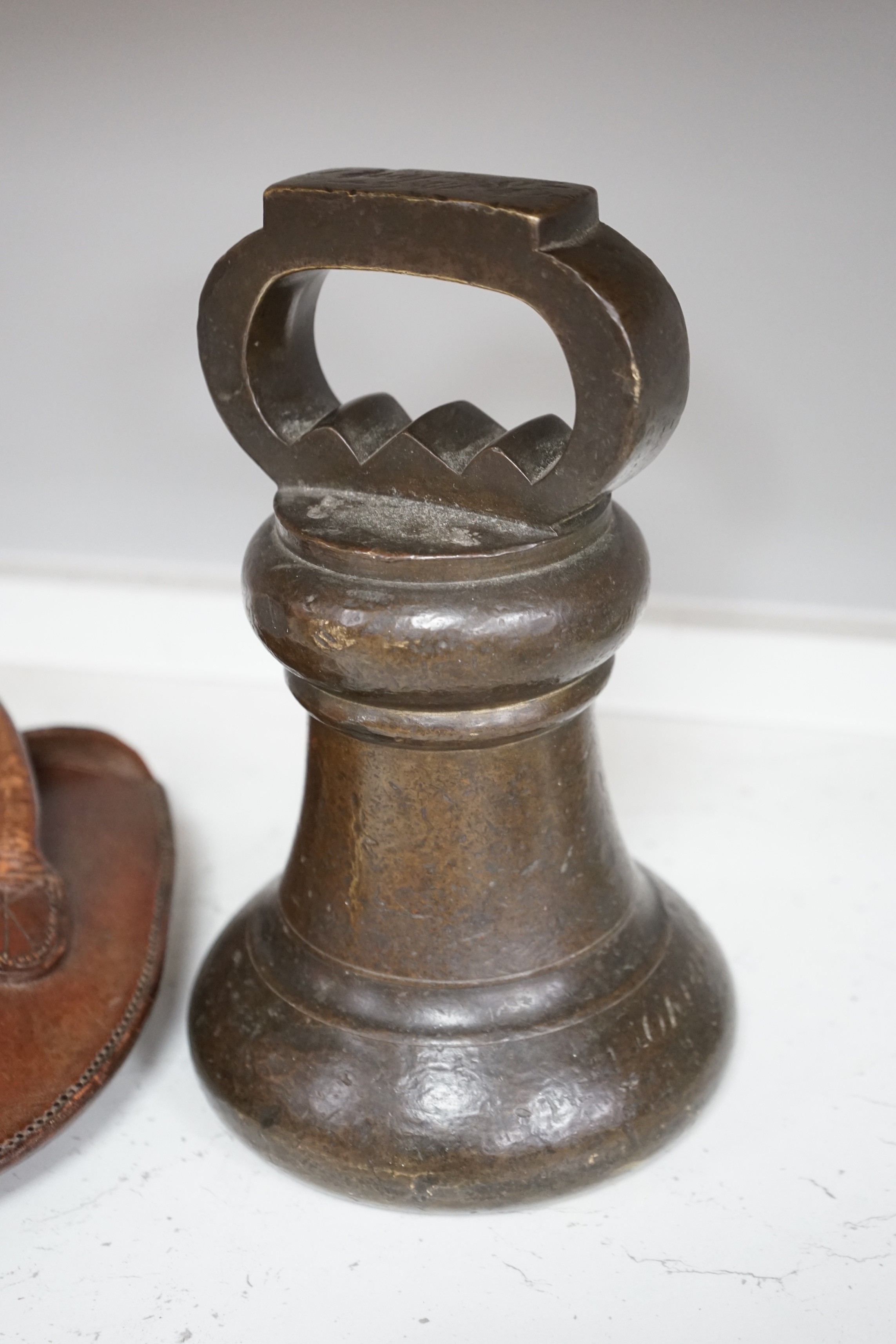 A single Victorian inscribed weight, together with quoits in brown leather case initialled G.H.